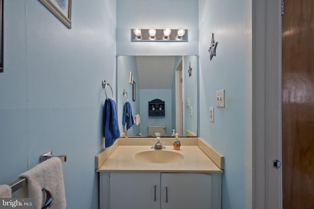 half bath featuring toilet and vanity