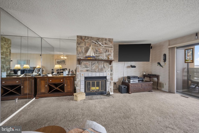 living area featuring a stone fireplace, visible vents, carpet floors, and a textured ceiling