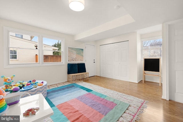game room with baseboards and wood finished floors