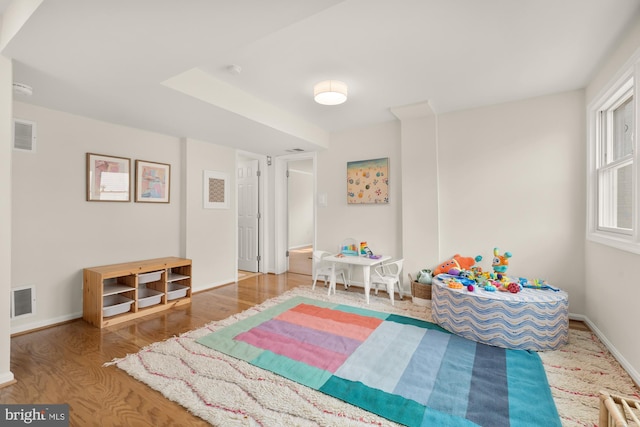game room with visible vents, baseboards, and wood finished floors