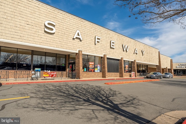 view of building exterior featuring uncovered parking