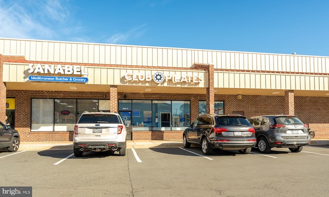 view of building exterior featuring uncovered parking