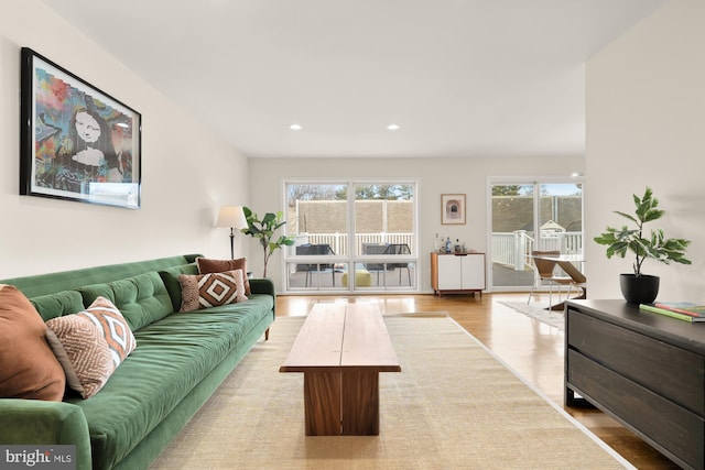 living room with recessed lighting and wood finished floors
