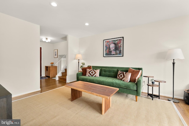 living room featuring stairway, baseboards, recessed lighting, and wood finished floors