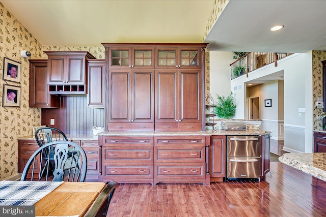 6 Ridgeview Way, Allentown, NJ 08501 - kitchen with baseboards, wallpapered walls, glass insert cabinets, light stone countertops, and wood-type flooring