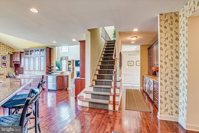 6 Ridgeview Way, Allentown, NJ 08501 - interior space with dark wood finished floors, visible vents, wallpapered walls, glass insert cabinets, and light stone counters