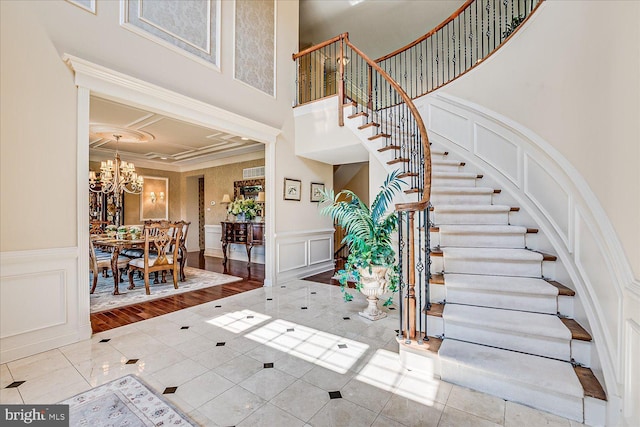 6 Ridgeview Way, Allentown, NJ 08501 - tiled entrance foyer featuring stairway, a decorative wall, a towering ceiling, and a chandelier