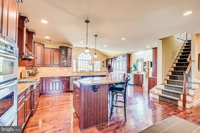 6 Ridgeview Way, Allentown, NJ 08501 - kitchen with glass insert cabinets, a kitchen breakfast bar, light wood finished floors, and appliances with stainless steel finishes
