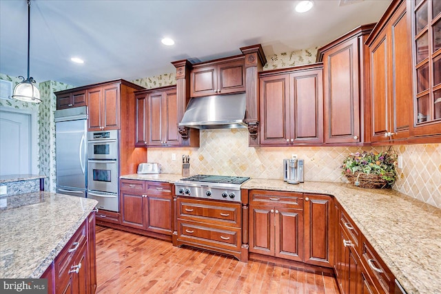 6 Ridgeview Way, Allentown, NJ 08501 - kitchen with hanging light fixtures, light wood-style floors, a warming drawer, stainless steel appliances, and under cabinet range hood