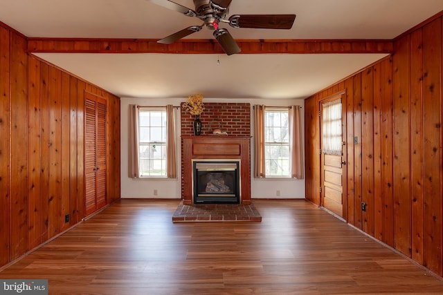 30 Cooper Ave, Marlton, NJ 08053 - unfurnished living room featuring a glass covered fireplace, wood finished floors, and wood walls