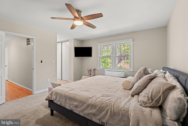 bedroom with carpet floors, a closet, ceiling fan, and baseboards