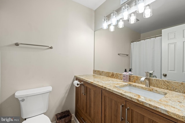 full bath featuring toilet and vanity