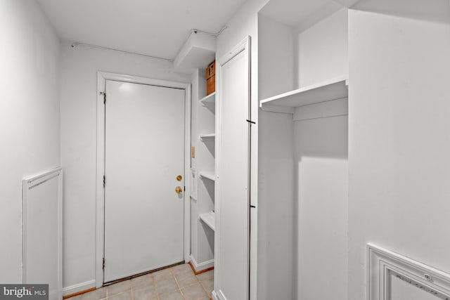spacious closet with light tile patterned flooring