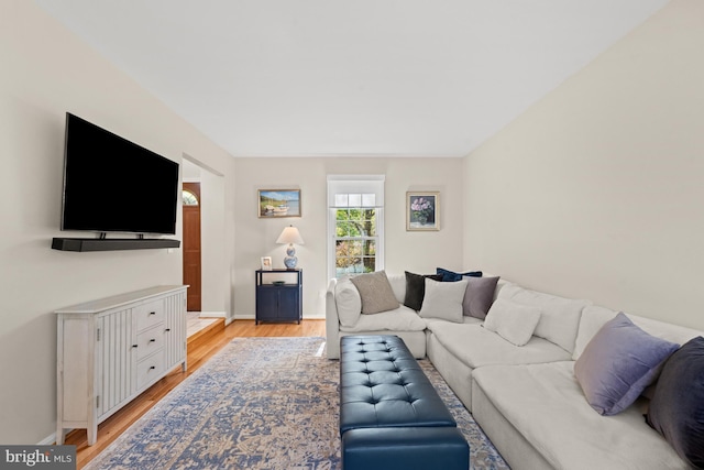 living area featuring light wood-type flooring and baseboards