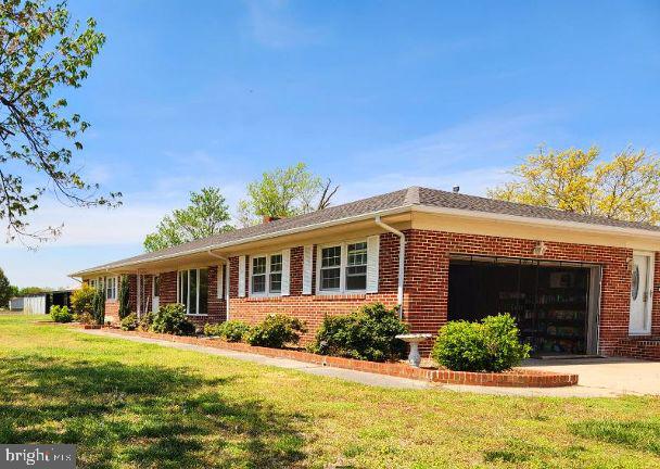 28964 Waller Rd, Delmar, MD 21875 - ranch-style home featuring concrete driveway, an attached garage, brick siding, and a front yard