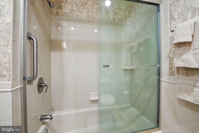 full bathroom featuring combined bath / shower with glass door
