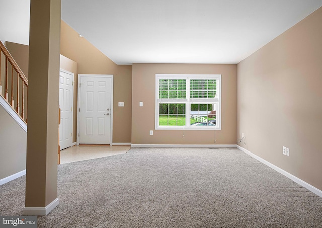 unfurnished living room with stairs, baseboards, light carpet, and lofted ceiling