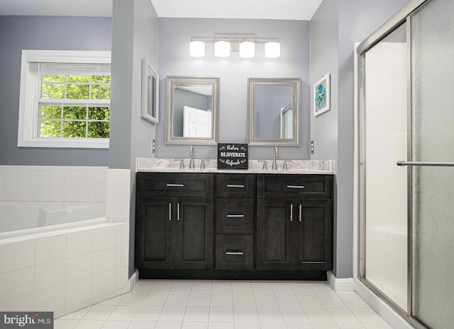 bathroom with a sink, double vanity, tile patterned floors, a garden tub, and a stall shower