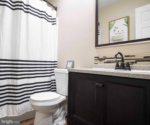 full bathroom with toilet, a shower with curtain, wood finished floors, and vanity