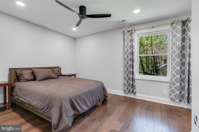 bedroom with recessed lighting, wood finished floors, visible vents, and baseboards