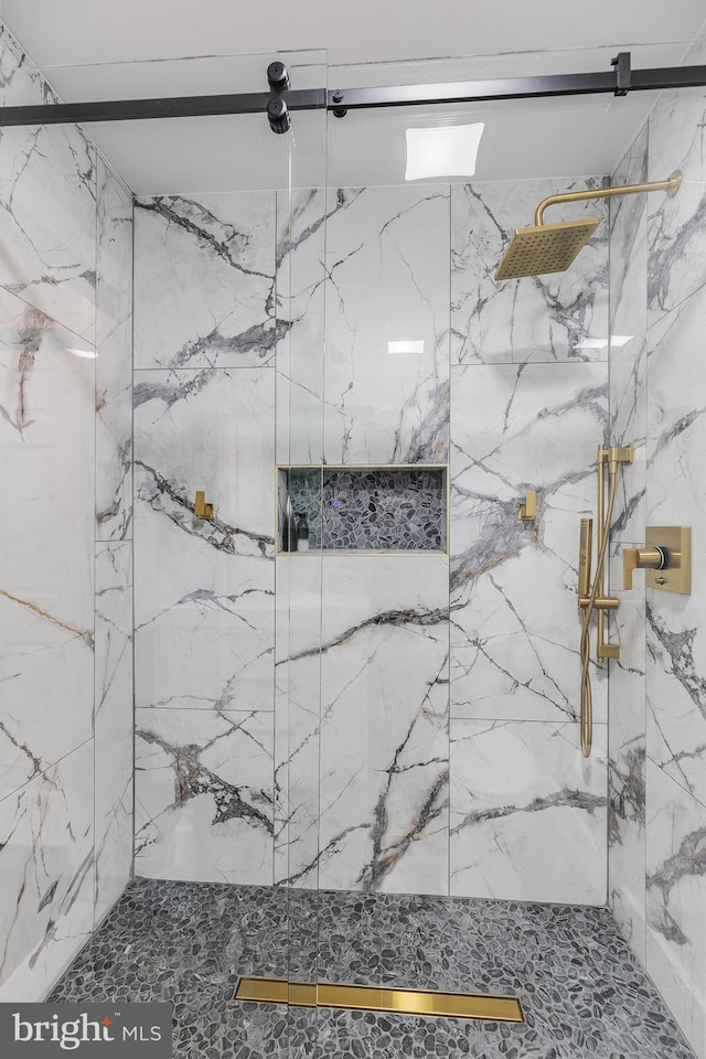 full bath with a marble finish shower