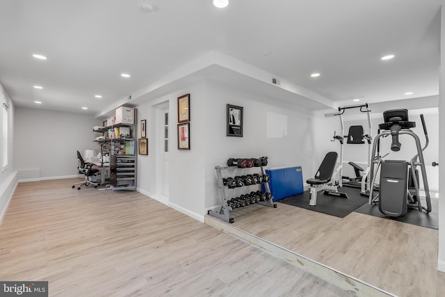 workout room with baseboards, wood finished floors, and recessed lighting
