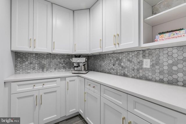 kitchen featuring open shelves, light countertops, and white cabinetry