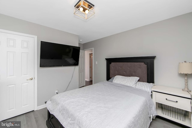 bedroom featuring baseboards and wood finished floors