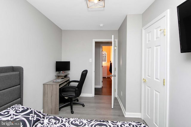 office area with wood finished floors and baseboards