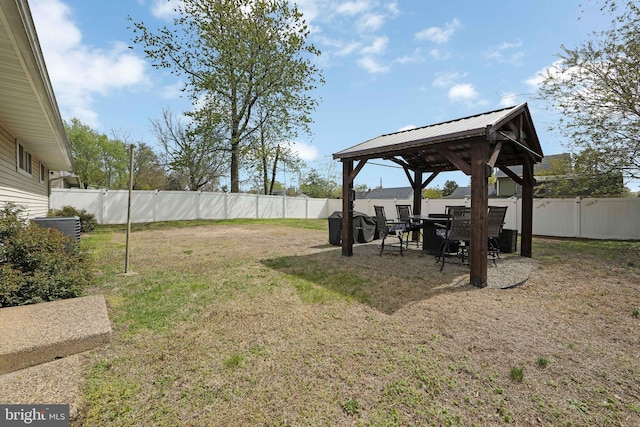 view of yard with a fenced backyard, a gazebo, and cooling unit