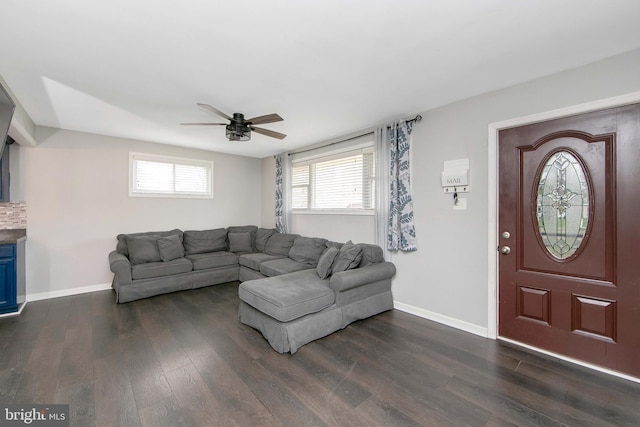 living area featuring baseboards, dark wood-style floors, and ceiling fan