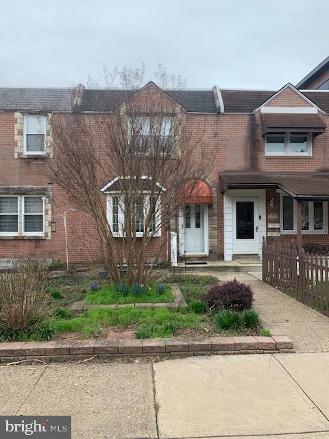 view of property with fence and brick siding
