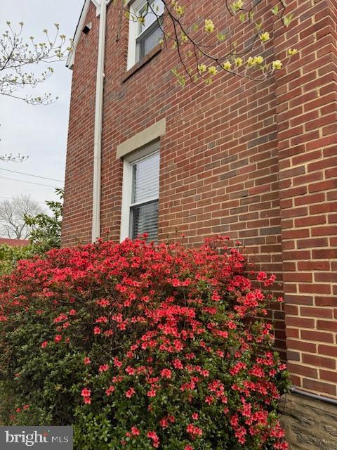 view of side of property featuring brick siding