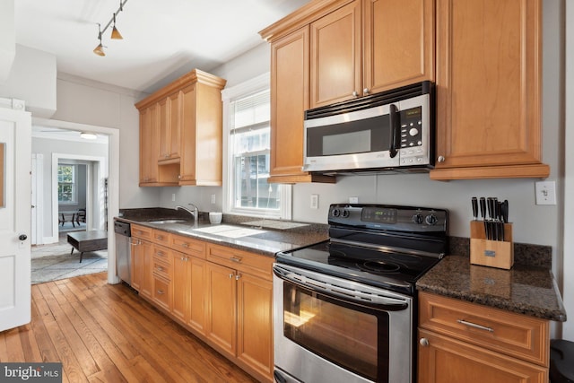165 King George St, Annapolis, MD 21401 - kitchen featuring stainless steel appliances, a sink, dark stone countertops, light wood-style floors, and track lighting