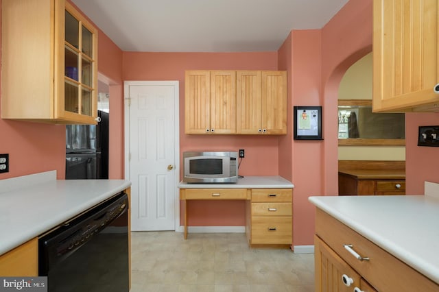 kitchen featuring arched walkways, light countertops, black appliances, glass insert cabinets, and light brown cabinets