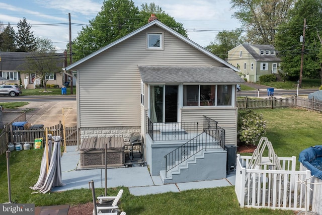 back of property featuring a fenced backyard and a yard
