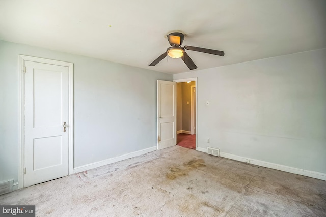 unfurnished bedroom featuring baseboards, carpet, a ceiling fan, and visible vents