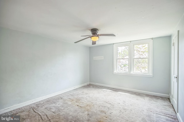 unfurnished room with baseboards, a ceiling fan, and carpet flooring