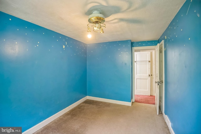 carpeted empty room with baseboards