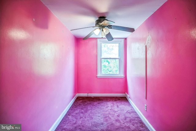 carpeted spare room with baseboards and a ceiling fan
