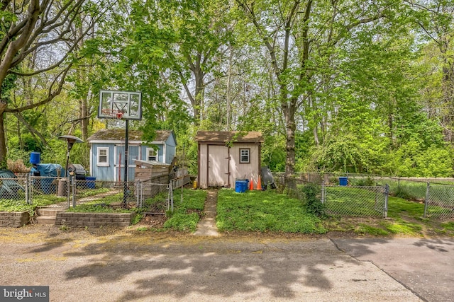 exterior space featuring fence and a storage unit