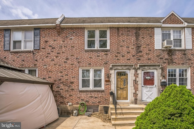 multi unit property featuring cooling unit and brick siding