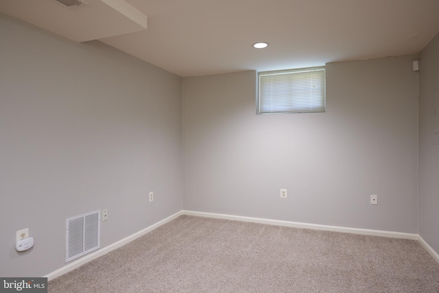 carpeted empty room with baseboards, visible vents, and recessed lighting