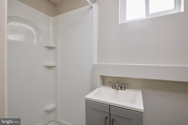 full bath with a shower and vanity