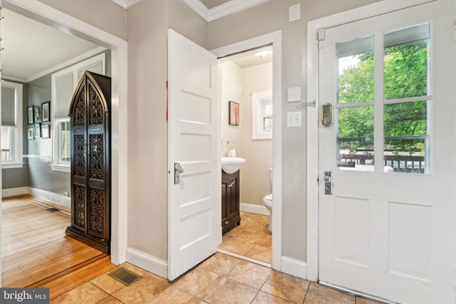 3330 Richmond Ave, Baltimore, MD 21213 - bathroom with ornamental molding, toilet, healthy amount of natural light, and baseboards
