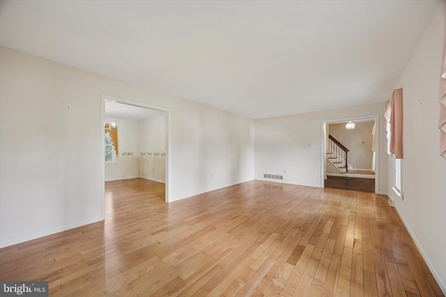 107 Timber Springs Ln, Exton, PA 19341 - spare room with light wood-type flooring, stairway, and a chandelier