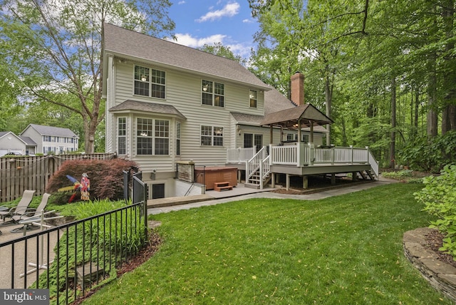 3211 Havenwood Ct, Edgewater, MD 21037 - rear view of property featuring a hot tub, a deck, a chimney, and a shingled roof