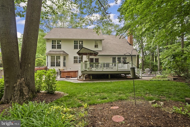 3211 Havenwood Ct, Edgewater, MD 21037 - rear view of house with a hot tub, a wooden deck, a chimney, a lawn, and a shingled roof