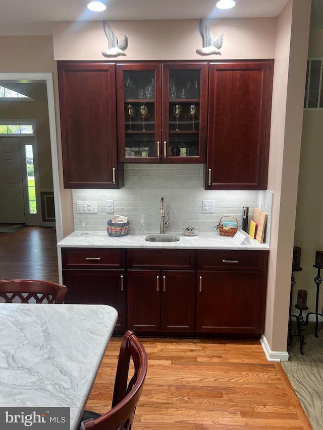3211 Havenwood Ct, Edgewater, MD 21037 - bar with a sink, decorative backsplash, and light wood-style floors