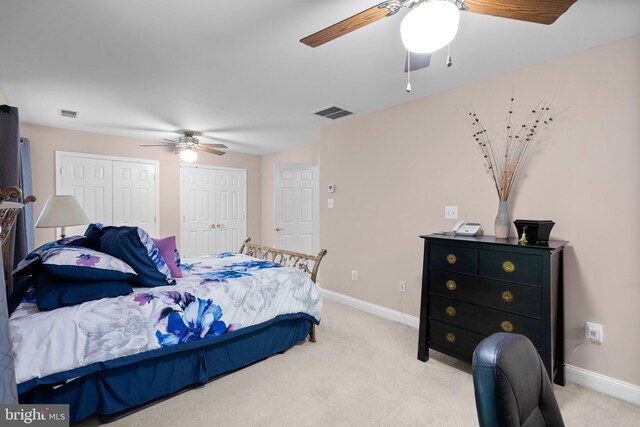3211 Havenwood Ct, Edgewater, MD 21037 - bedroom with multiple closets, light carpet, baseboards, and a ceiling fan
